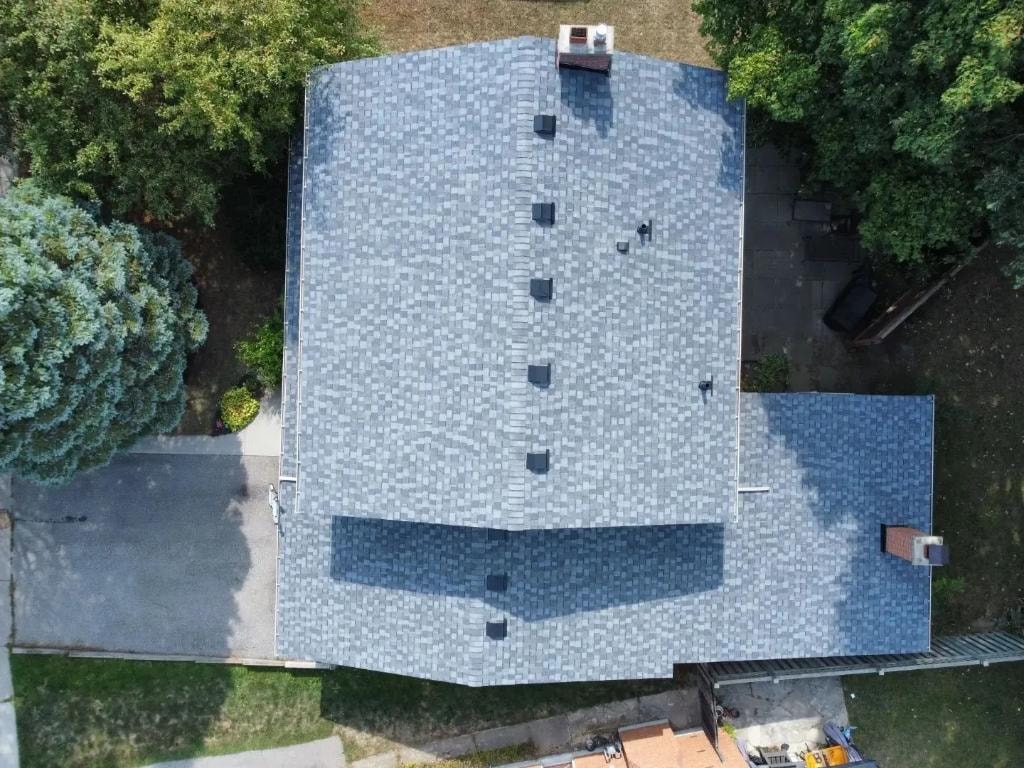 Aerial drone view of completed shingle roof with ridge vents