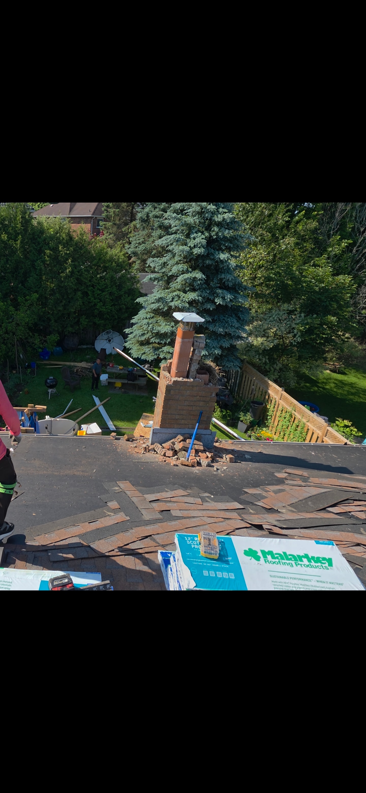 Chimney stack removal and roof patching on a residential home
