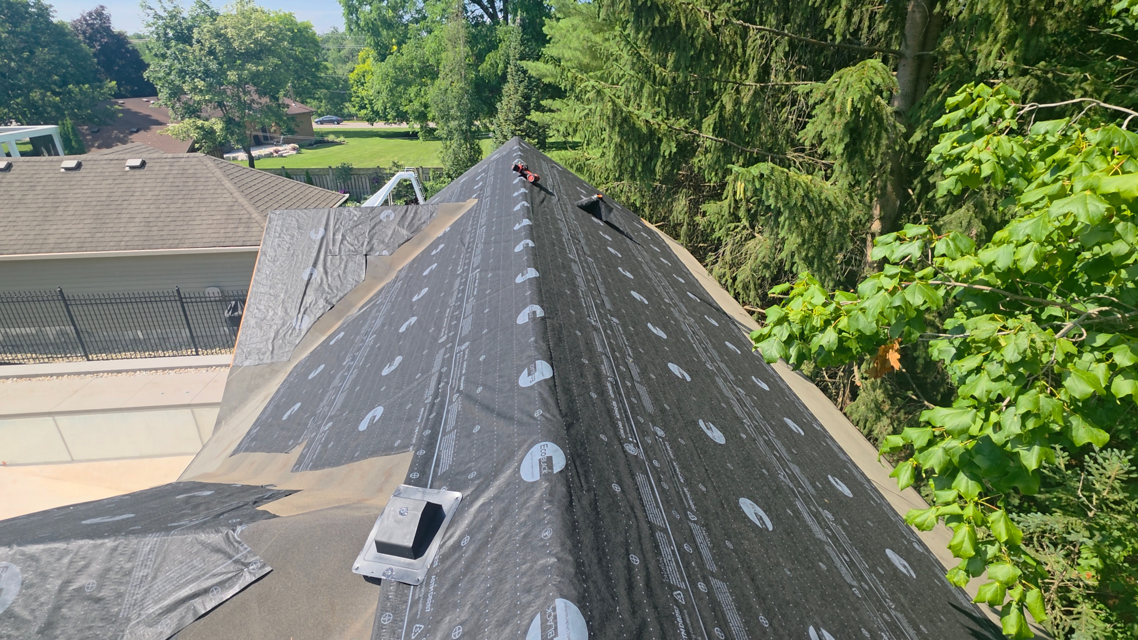 Ice and water shield underlayment being installed on roof